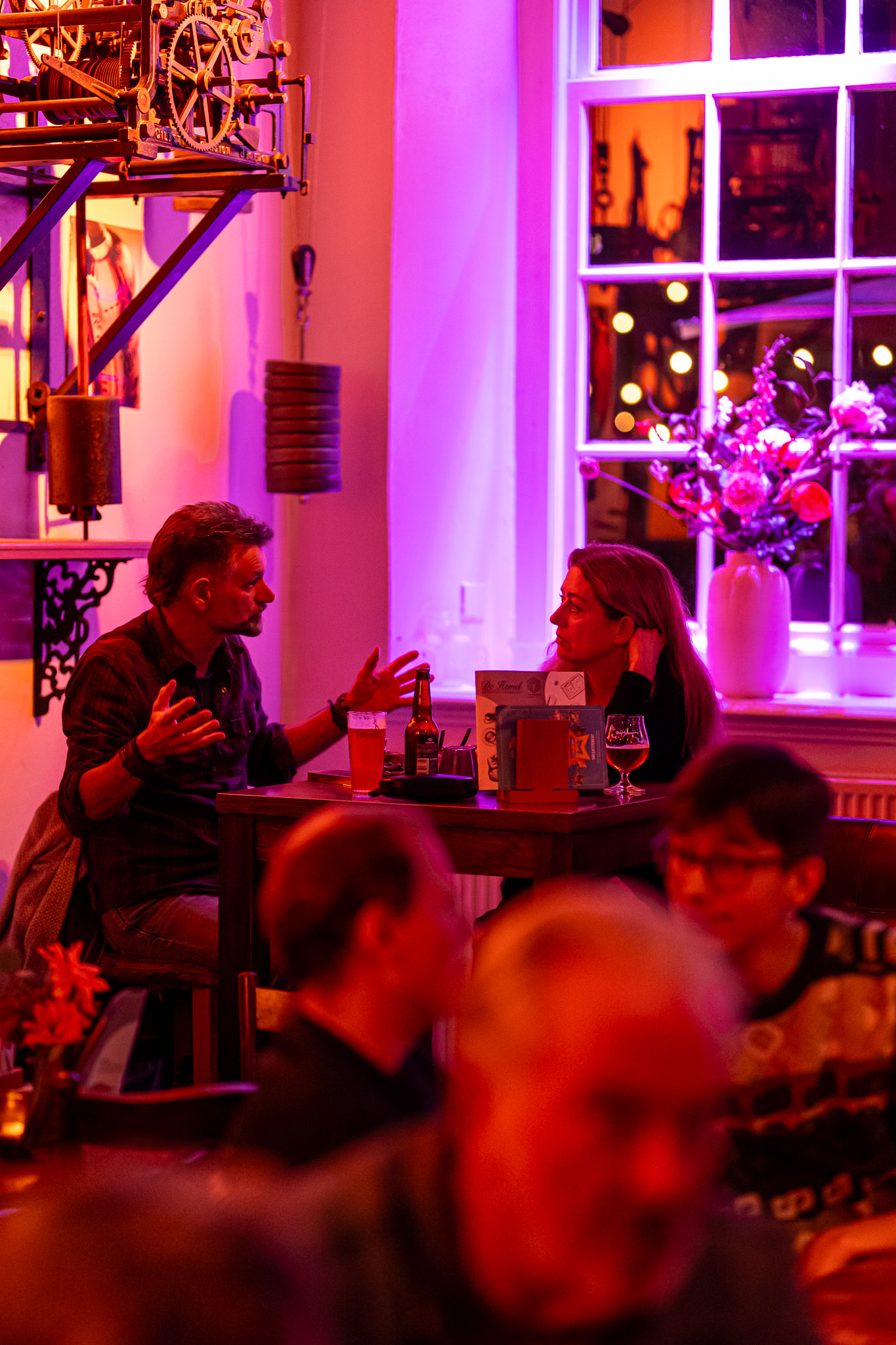 Gasten aan de borrel met huisgebrouwen bier in het Brouwerscafé van De Hemel